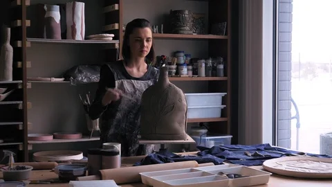Ceramist creates a pattern and relief dolly shot Stock Footage 104872098
