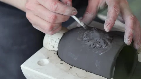 A ceramist creating a clay mug using tools. Stock Footage 275114676