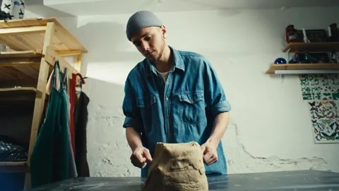 A ceramist cuts clay in the workshop on a table. Stock Footage 241232326
