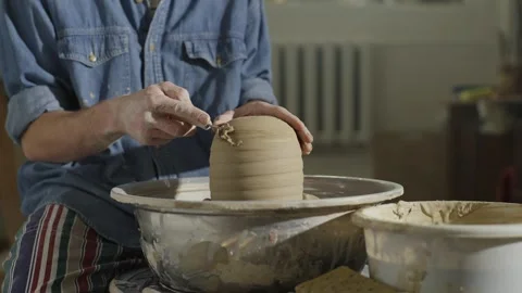 The ceramist cuts off the extra layer with a special blade on the potter's wheel Stock Footage 253395785