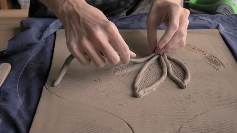 Ceramist lays out a pattern on the future vase for flowers, dolly shot Stock Footage 104881766