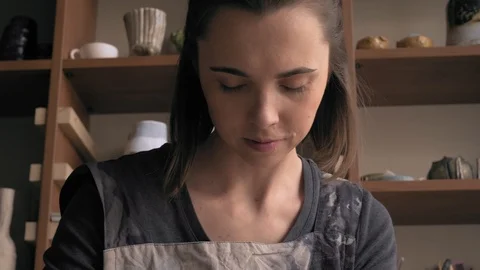 Ceramist lays out a pattern on the future vase for flowers, dolly shot Stock Footage 104881825