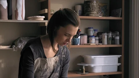 Ceramist lays out a pattern on the future vase for flowers, dolly shot Stock Footage 104882059