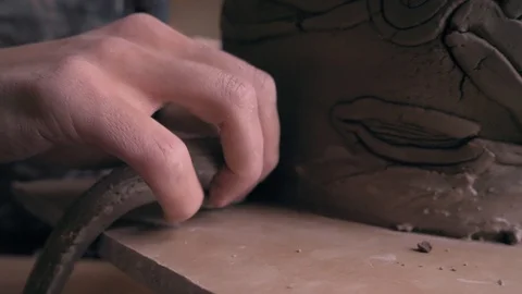 Ceramist lays out a pattern on the future vase for flowers, dolly shot Stock Footage 104882876