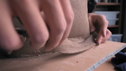 Ceramist lays out a pattern on the future vase for flowers, dolly shot Stock Footage 104882955
