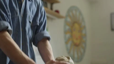 A ceramist prepares clay by hand for the work of making a figurine. Stock Footage 245345536