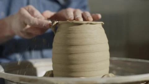 The ceramist removes excess clay with a special knife on the potter's wheel. Stock Footage 252831653