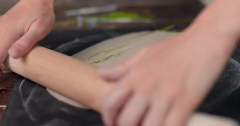 Ceramist using a roller and herb to print on a clay. Close-up, slow motion Stock Footage 155618543