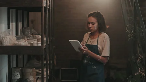 Ceramist Using Tablet Computer by Rack Stock Footage 169862234
