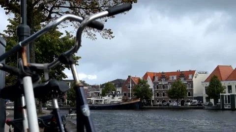 Cerda del rio bicycles and boats passing in Haarlem, Netherlands Stock Footage 166754966