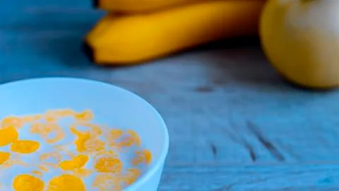 Cereal and fruit for Breakfast on the table. Delicious food at h Stock Photos