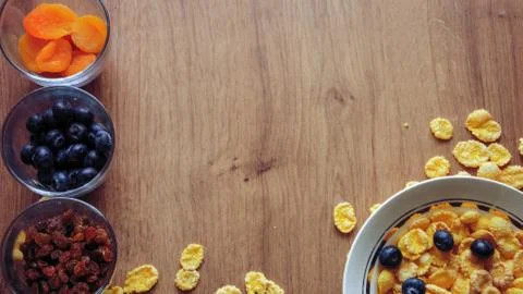 Cereal and fruit for Breakfast on the table. Delicious food at h Stock Photos