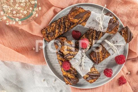 Cereal bars with raspberries on kitchen counter top. Stock Photos