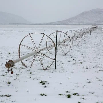 Cereal fields with irrigation wheels with snow in Nevada Stock Photos