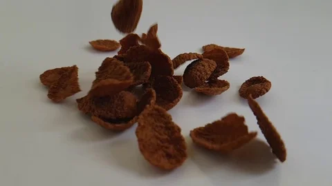 Cereal flakes against a white background fly, slow-motion Stock Footage 87945407