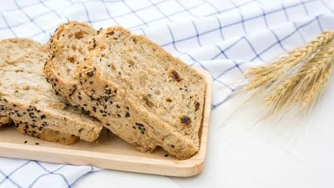Cereal grains bread on a white table. Stock Photos