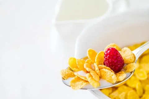 Cereal in spoon with raspberry, isolated on white Stock Photos