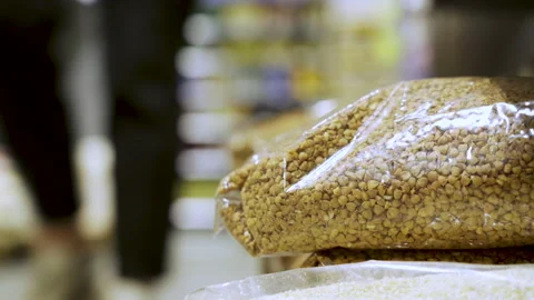 Cereal on the store shelf and in the hands of the buyer Stock Footage 220087983