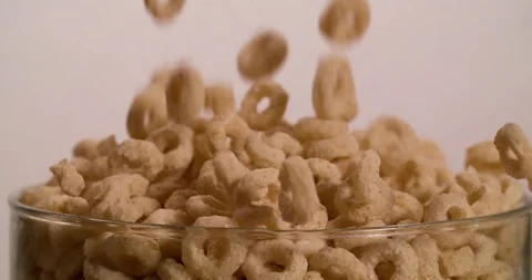Cereal tubes circles falling in glass bowl 4K video Stock Footage 108812960