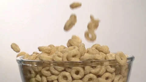 Cereal tubes circles falling pouring in Bowl Slow motion Stock Footage 107939583