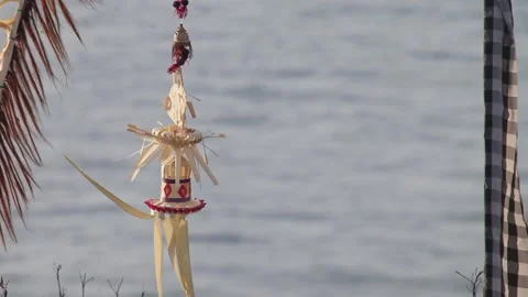 Ceremonial Palm Leaf Craft Hanging at Stone Temple Shrine in Bali Stock Footage 345219357