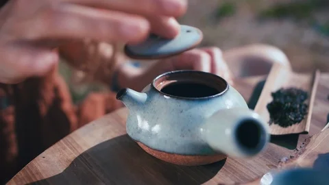 Ceremony making and serving tea pouring hot water into teapot using natural tool Stock Footage 96761534