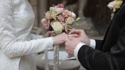 At the ceremony of marriage.  loving bride and groom put rings on each other as. Stock Footage 90232853