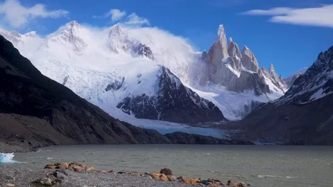 Cerro Torre rises high above the wind-whipped waters of Laguna Torre in Fitz Roy Stock Footage 134549465