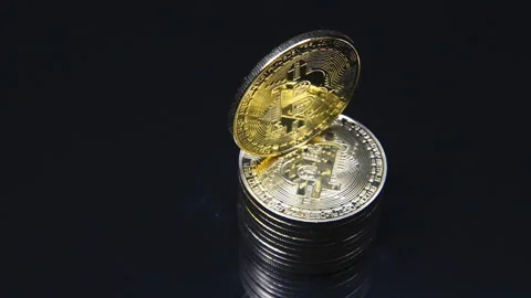 Certain amount of gold bitcoins rotates on a black background	 Stock-Footage 101301320