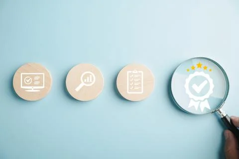 Certification and ISO quality concept illustrated with a magnifying glass Stock Photos