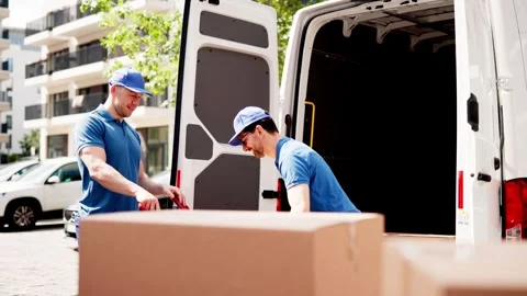 Certified Mover unloading van and carrying boxes for approved moving services 스톡 동영상 279800377