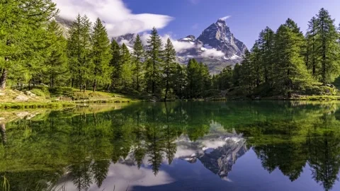 Cervino mountain reflected with the pine trees in the Blue Lake 動画素材 167654148