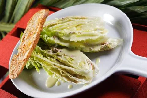 Cesar salad with lemon dressing, walnuts and cheese-toasted bread. Stock Photos