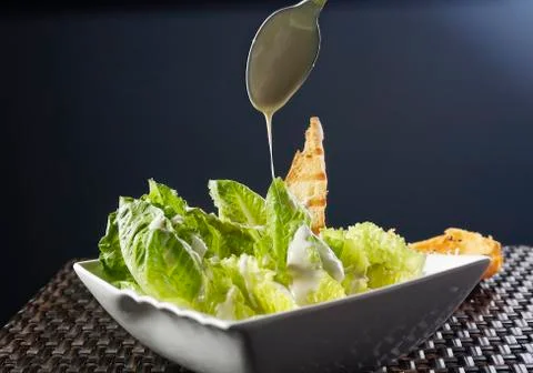 Cesar salad with lemon dressing, walnuts and cheese-toasted bread. Stock Photos