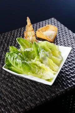 Cesar salad with lemon dressing, walnuts and cheese-toasted bread. Stock Photos