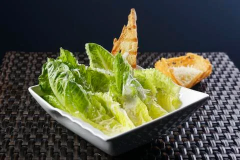 Cesar salad with lemon dressing, walnuts and cheese-toasted bread. Stock-Fotos
