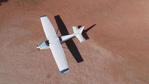 Cessna 172 parking after flight on dirt airstrip Stock Footage 92556716