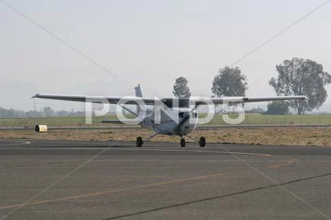 Cessna airplane landing and taxiing Stock Photos