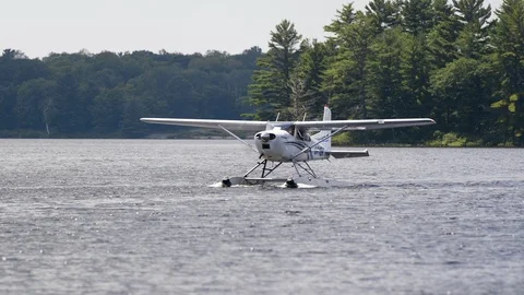 A Cessna Float Plane Taxis across a small lake. Stock Footage 91414082