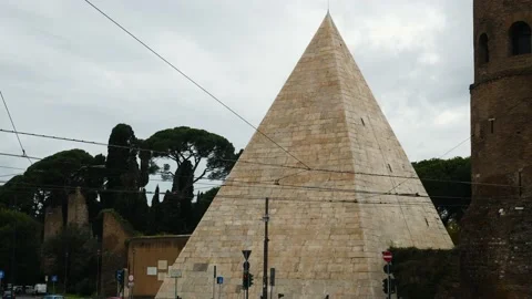 Cestia Pyramid, tilting down to people and car traffic. 4k. City life. Rome Stock Footage 141592018