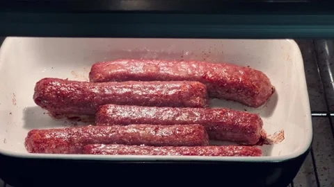 Cevapchichi or cutlets are baked in the oven on a white dish, video of how fat i 库存影片 256142722