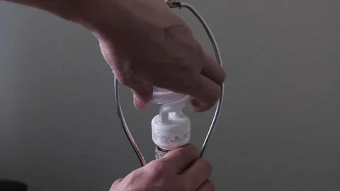 CFL light bulb is removed from a lamp Stock Footage 296998332