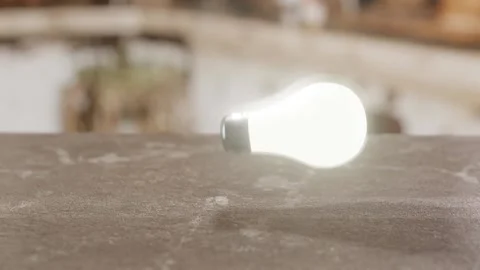 CGI Rendering of a slow motion glowing lightbulb that falls and shatters Stock Footage 165252017