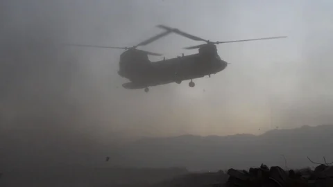 CH-47 Chinook creating dust storm while hovering in Afghanistan Stock Footage 100753583