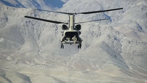 CH-47 Chinook flies through mountains of Afghanistan with rear door open Stock-Footage 87318677