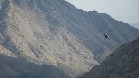 CH-47 Chinook flying between mountains of Afghanistan Stock Footage 87319164