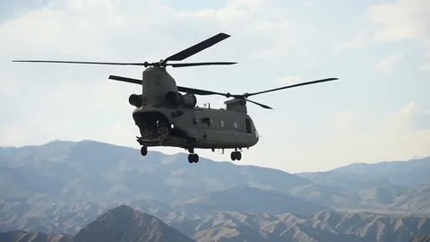 CH-47 Chinook hovering above mountains of Afghanistan Stock-Footage 87319223