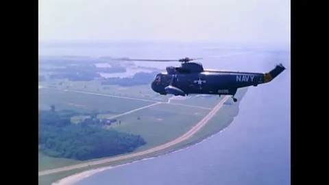 CH-53A helicopter in flight, with a UH-1D type helicopter hanging from a-sling, Stock Footage 117053618