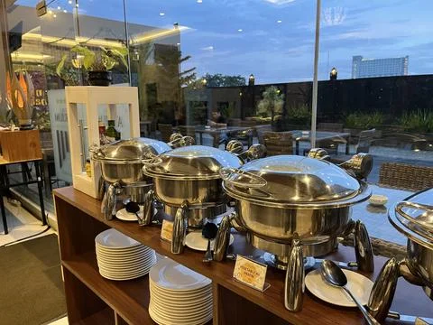 Chafing dishes on the table in a restaurant. Stock Photos