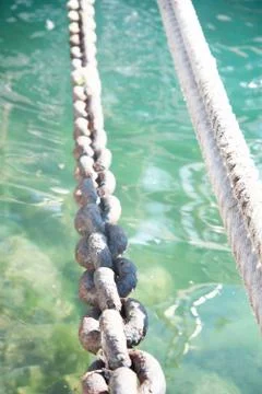 The chain and cable from the ship on a background of sea water Stock Photos
